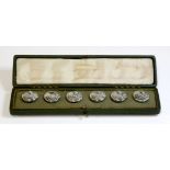 A cased set of sterling silver Arts and Crafts Cymric buttons, c.1900, by Liberty & Co.  The set