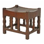 An oak stool, with a dish top, raised on chamfered supports, 43cm wide 33cm deep 38cm high