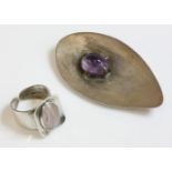 A sterling silver amethyst brooch, c.1970, by Frederick Keith Richards, composed of a concave pear
