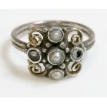 A silver and gold Arts and Crafts split pearl cluster ring, attributed to Dorrie Nossiter.  A