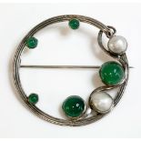 An Arts and Crafts silver agate and blister pearl circle brooch, with a reeded hoop, decorated