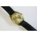 A gentlemen's gold-plated Omega Automatic GenŠve strap watch, c.1960, the case 34mm diameter, with a