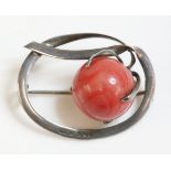 An Edwardian sterling silver coral bead brooch, with a flat section oval frame.  A 15mm coral