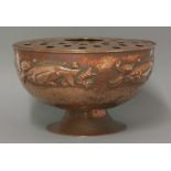 A Newlyn copper pedestal rose bowl, the sides embossed with fish on a hammered ground below a