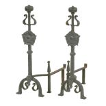 A pair of Arts and Crafts wrought iron fire dogs, with English rose bosses, 79.5cm high (2)