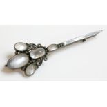 A silver Arts and Crafts moonstone brooch, attributed to Dorrie Nossiter.  A cluster of oval