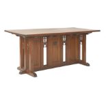 A Gothic pitch pine altar table, the rectangular top over pierced side and central panels, with a