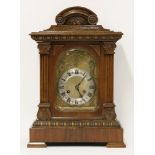 A late19th/early 20th century German eight day mantel clock, within an oak case, with pendulum and