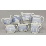 Seven mid 19th century jugs, each with white sprigs against a blue ground, various makers and