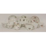 Eight assorted hand painted and press moulded tea cups and saucers, a pair with puce sprigs and