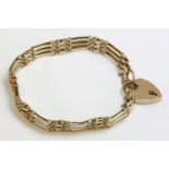 An Edwardian gold three row gate bracelet, with sets of figure of eight joining links, marked 9ct