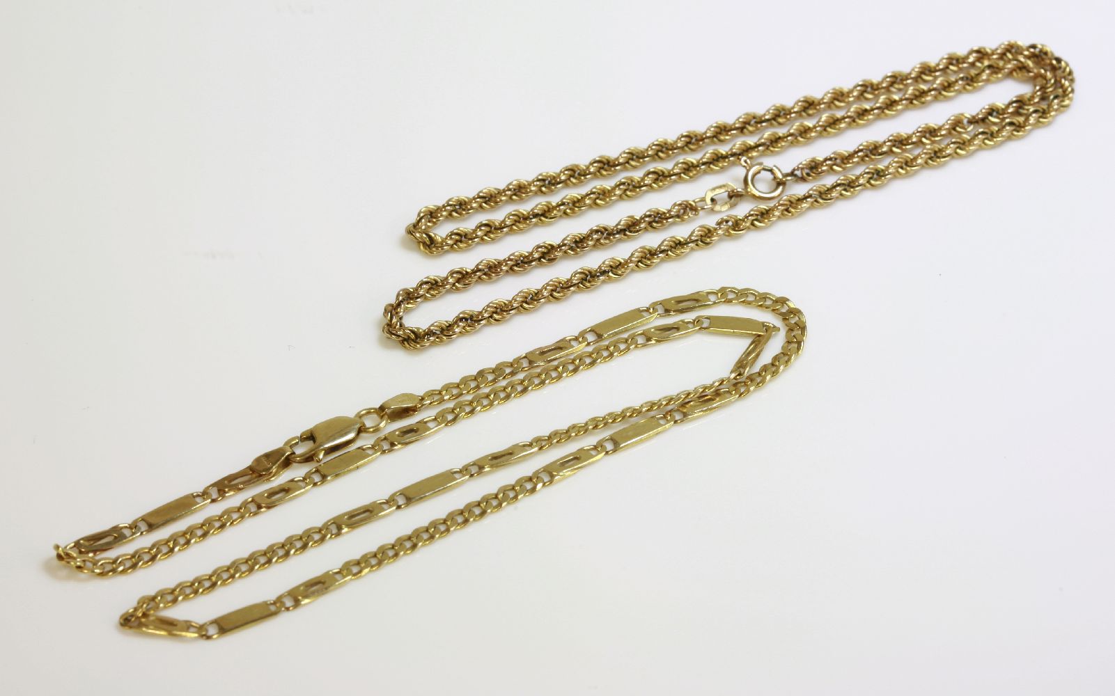 A 9ct gold curb and bar link chain, and a 9ct gold rope chain (2)