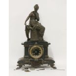 A French black slate mantel clock, surrounded with a seated figure of a lady with doves, on paw