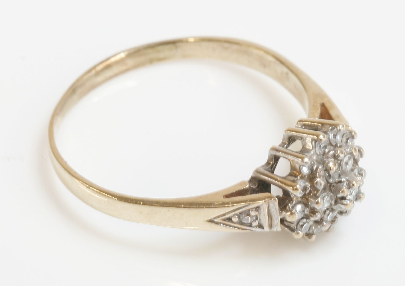 A 9ct gold diamond cluster ring, with diamond set shoulders