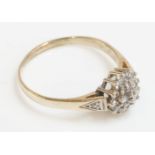 A 9ct gold diamond cluster ring, with diamond set shoulders