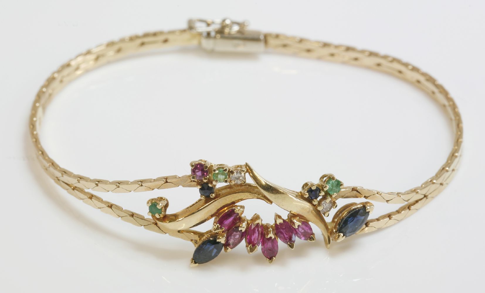 An Italian gold bracelet, composed of two rows of cobra chain with a dispersed cluster of rubies,