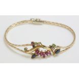 An Italian gold bracelet, composed of two rows of cobra chain with a dispersed cluster of rubies,