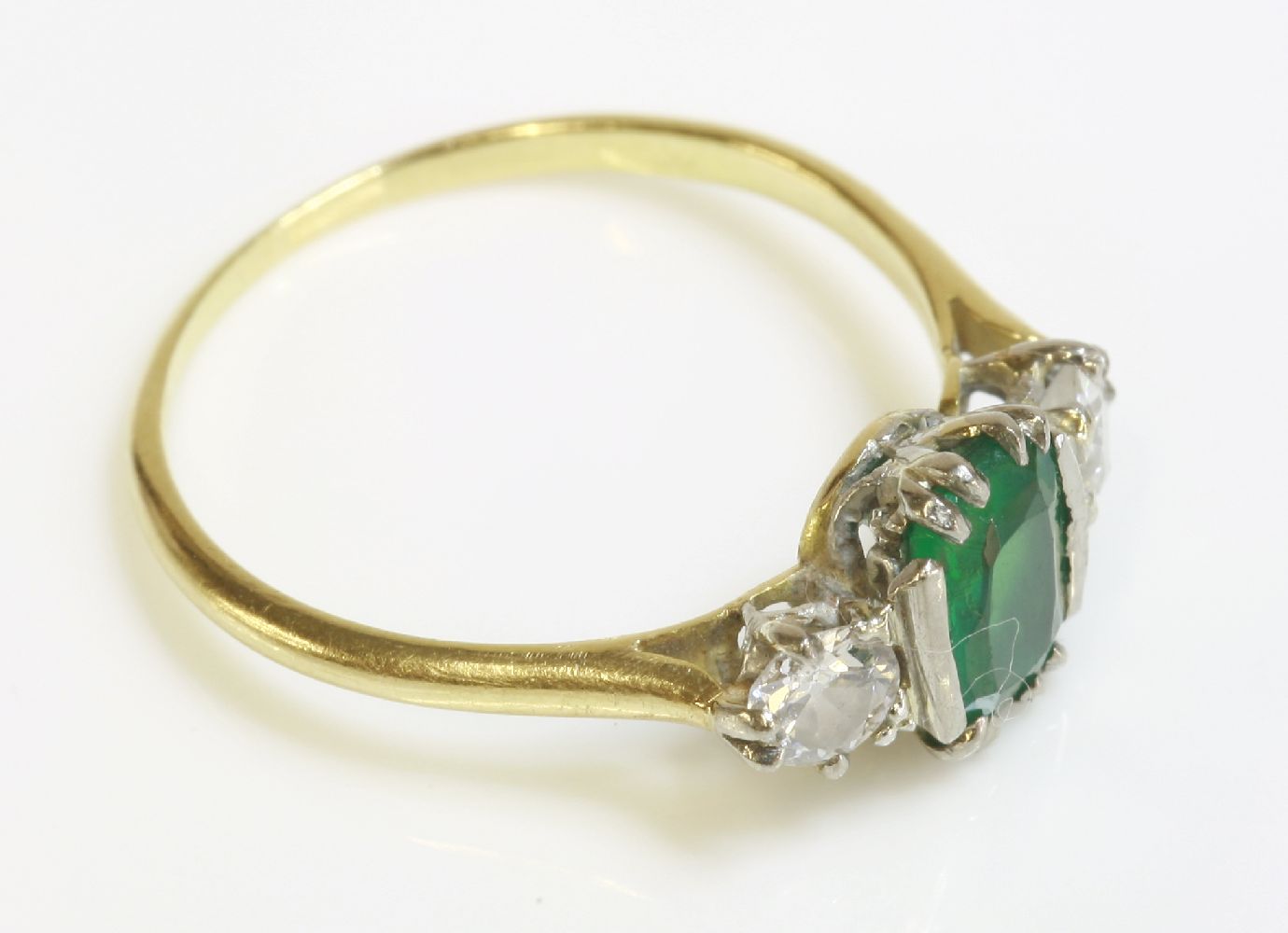 A green doublet and diamond three stone ring