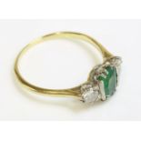 A green doublet and diamond three stone ring