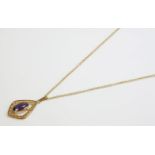 A 9ct gold amethyst pendant, rub set to a kite shaped frame, suspended on a 9ct gold trace chain