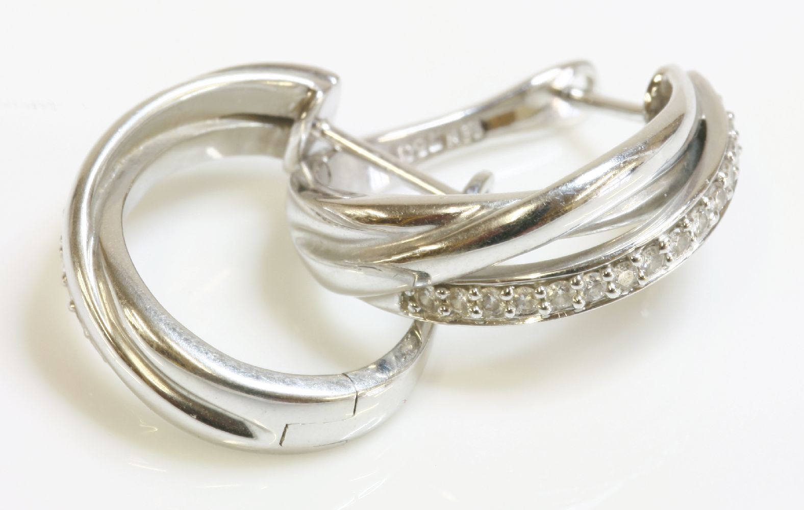 A pair of Continental white gold diamond set hoop earrings, of Russian wedding ring style, marked