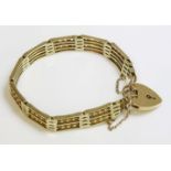An Edwardian gold three row gate bracelet, with floral bars between, marked 9c, with a later 9ct
