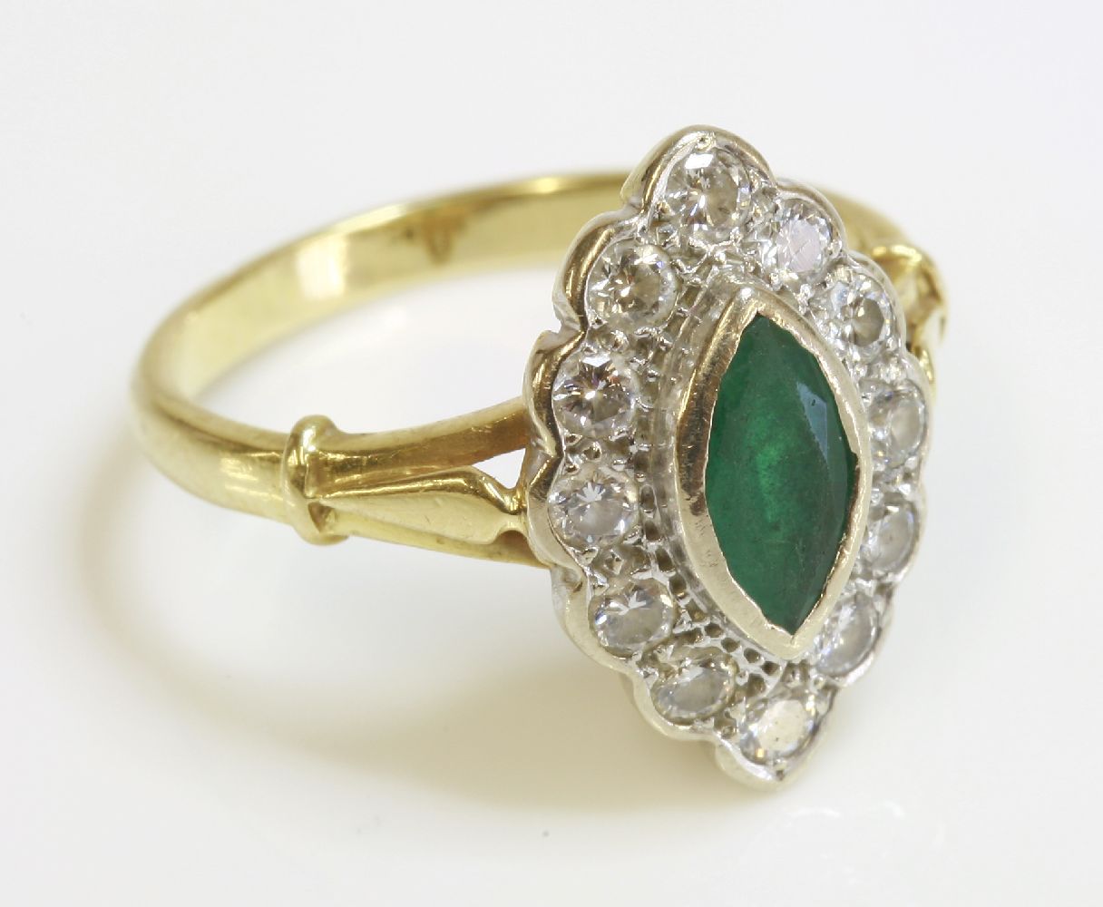 An 18ct gold emerald and diamond marquise shaped cluster ring