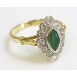 An 18ct gold emerald and diamond marquise shaped cluster ring