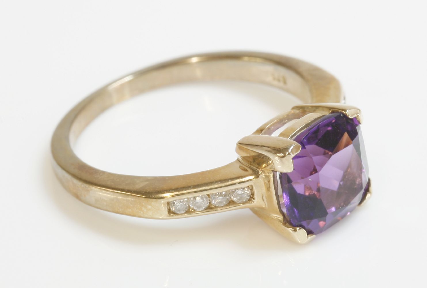 A 9ct gold single stone amethyst ring, with channel set diamond shoulders