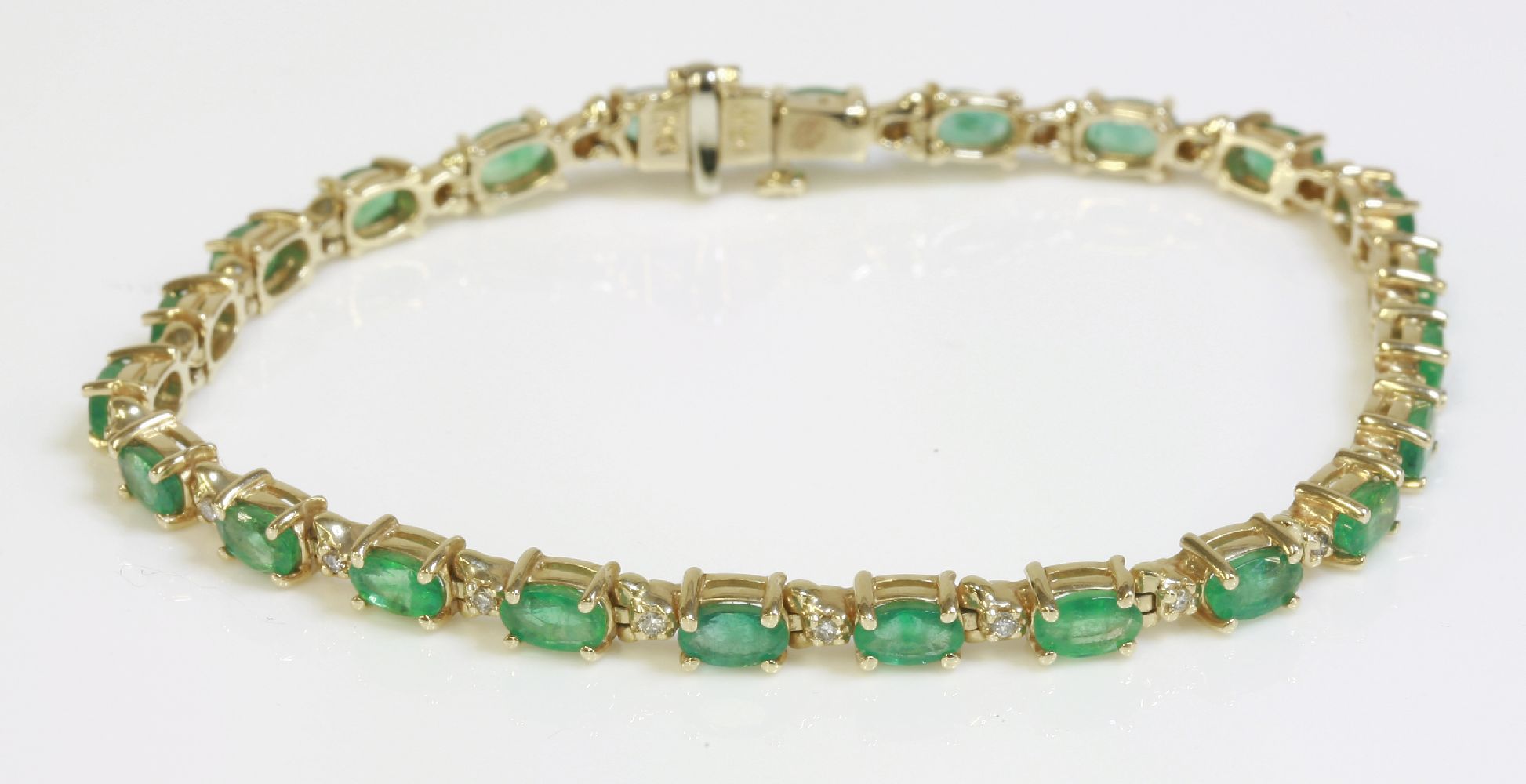 An emerald and diamond gold line bracelet, marked 14K