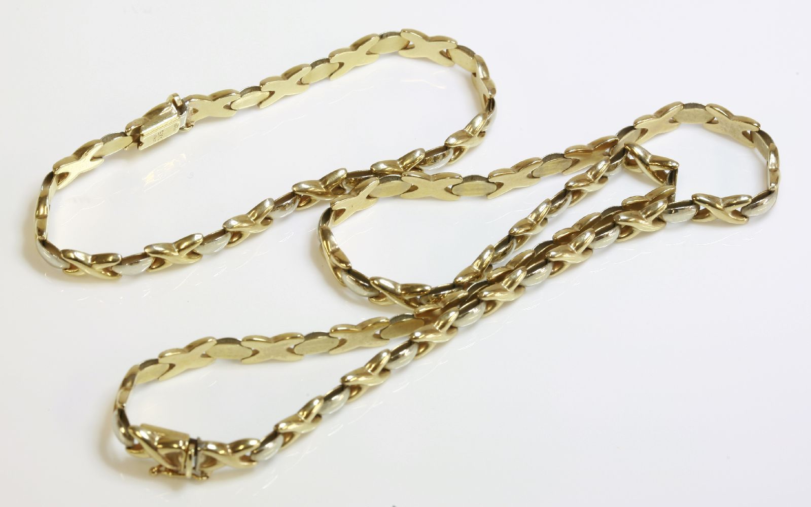 A 9ct two colour gold kiss link necklace and bracelet suite (2)