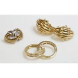 A pair of 18ct gold diamond set hoop earrings, a pair of 9ct gold diamond set stud earrings, and a
