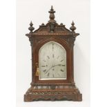 A good Victorian oak mantel clock,the carved case housing a three train musical movement, striking