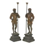 A pair of cast figures,after originals by A Guillot, each dressed in medieval clothes holding