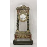 A French ebonised portico clock,late 19th century, under a rectangular glass dome decorated with