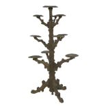 A Black Forest carved softwood plant stand,worked as a tree trunk with ten plant stands on a