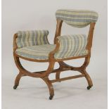 An Edwardian inlaid satinwood 'X' framed chair, with upholstered back rail, arms and seat,