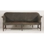 A George III oak settee,with a straight back and scrolled arms, worn leatherette upholstery