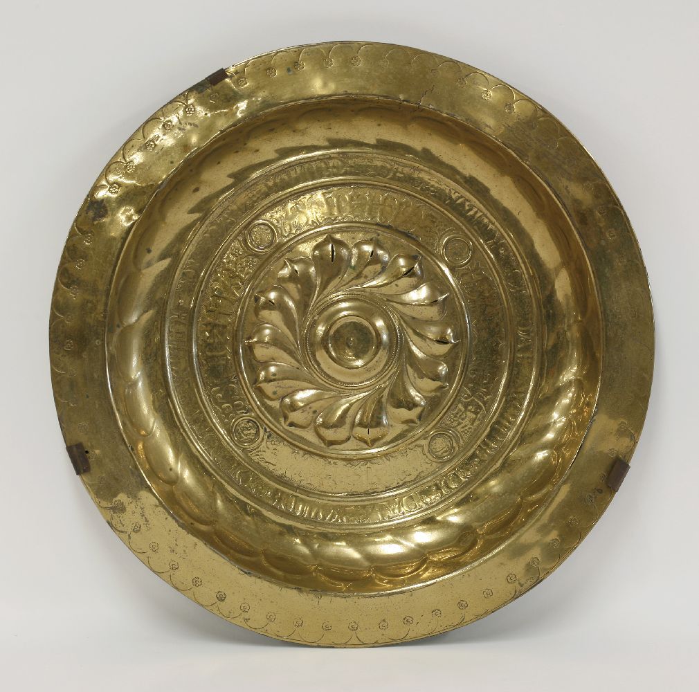 A brass alms dish,Nuremberg, 16th century, the central boss with whorls and with two lines of