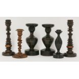 Two pairs of treen candlesticks,the first pair in lignum vitae, with ornamental engine turned