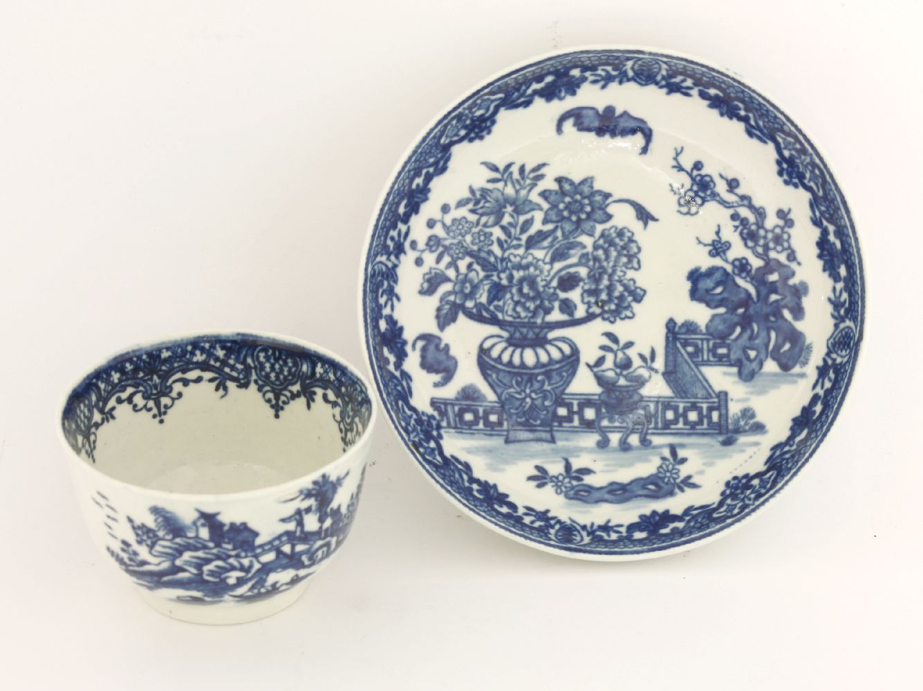 A Worcester blue and white Tea Bowl and Saucer,c.1780, printed in 'The Bat' pattern, disguised