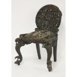 An Anglo-Indian rosewood child's chair, c.1870, with a rounded back carved and pierced with a