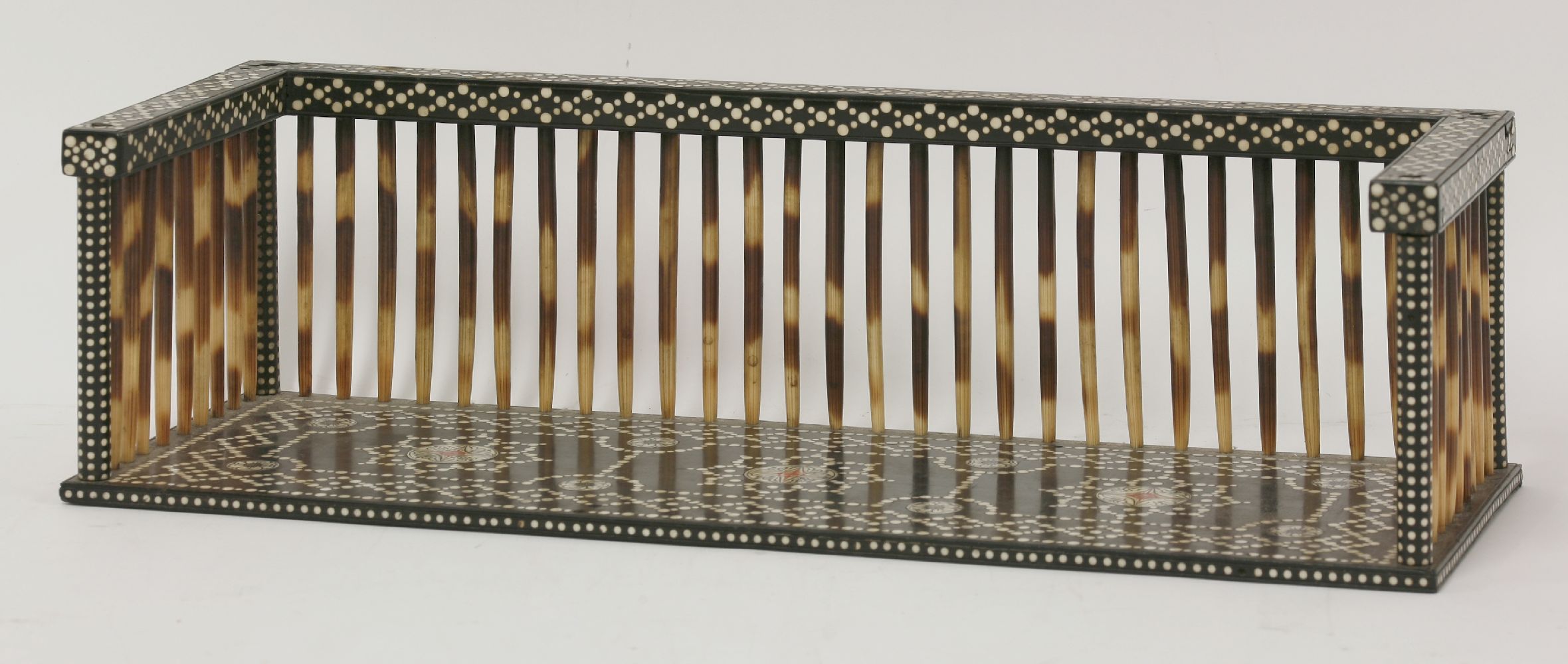 An Indian inlaid ebony and porcupine quill bookrack,c.1900,45cm wide