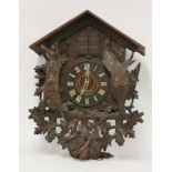 A 'Black Forest' cuckoo wall clockwith carved dead hare and woodcock, oak leaves, gun and powder