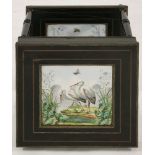 A French ebonised and gilt metal mounted table,inset with two tiles, depicting a pair of herons to