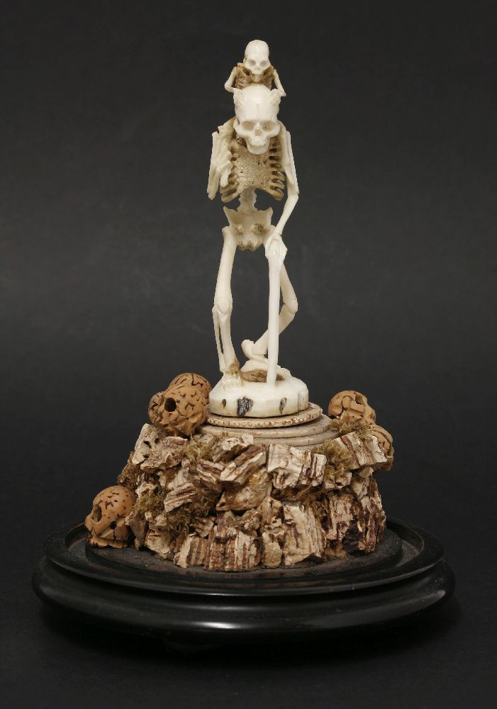 A bone and cork group,late 19th century, depicting a skeleton holding a walking stick, with a - Image 2 of 4