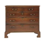 A George III mahogany chest of drawers, with brushing slide, two short over three long drawers and