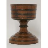 Seven treen items,a walnut pedestal cup, with finely turned mouldings,17cm,a lignum vitae goblet,