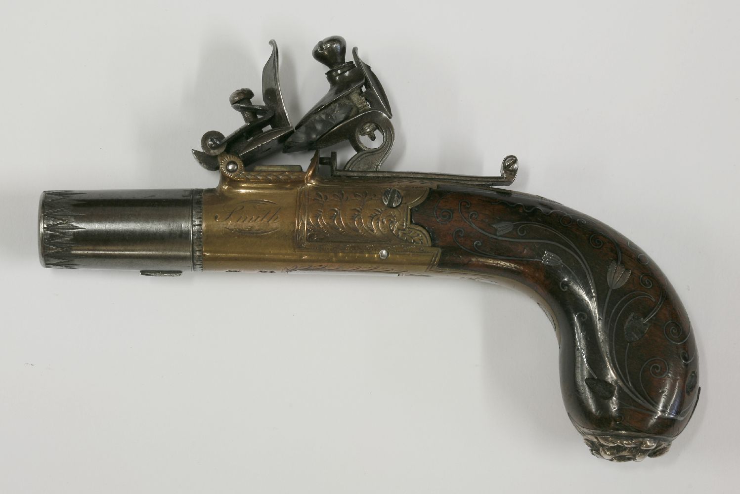 A flintlock pocket pistol, c.1800, by Smith, London, with turn-off barrel and brass stock,