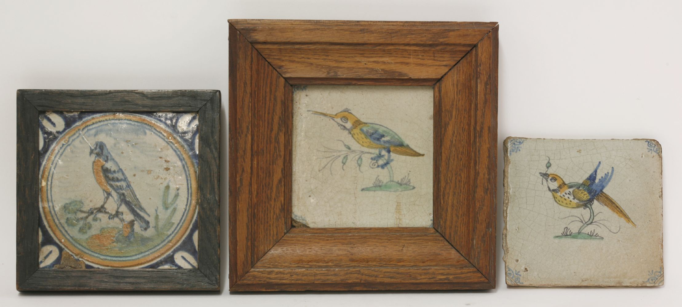 Three various delft Tiles,17th/18th century, each painted with a bird,13cm, framed   (3)